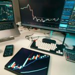 A modern trading desk with screens displaying financial charts and graphs, showcasing a digital analysis setup.